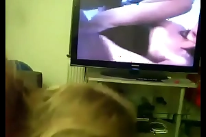 Mom gives son head while he watches porn